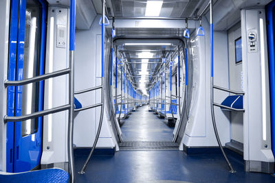 Interior of illuminated modern metro train 