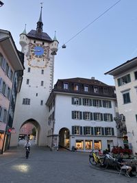 Buildings in town against clear sky