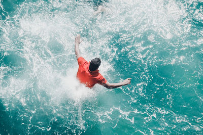Directly above shot of man diving into sea