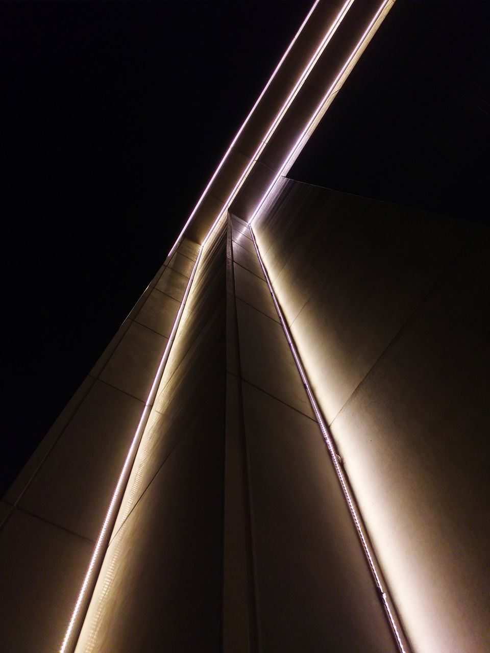 LOW ANGLE VIEW OF ILLUMINATED LIGHTING EQUIPMENT AGAINST SKY