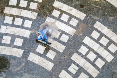 High angle view of a man sitting against building