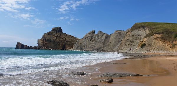 Rocks on beach against sky