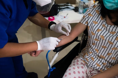 Rear view of mother with hands, blood transfusion, healthcare 