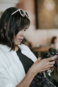 Portrait of woman holding camera