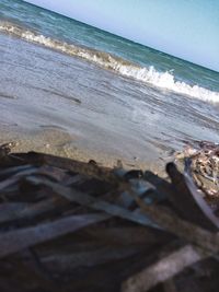 Close-up of wave on beach against sky