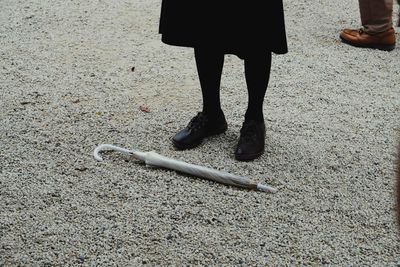Low section of woman standing on street