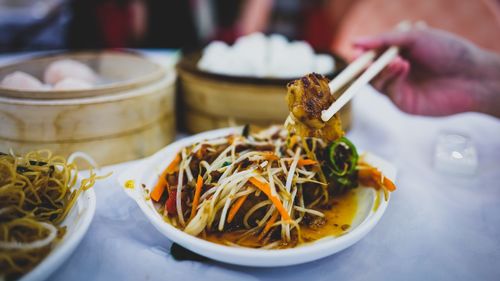 Cropped image of person having food at table