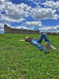 Scenic view of grassy field against sky