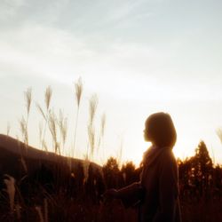 Silhouette of woman on field