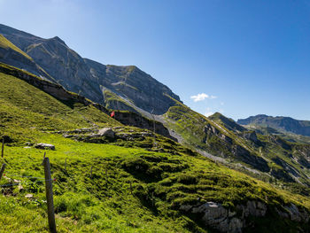 Scenic view of mountains against clear blue sky