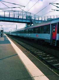 Train at railroad station against sky