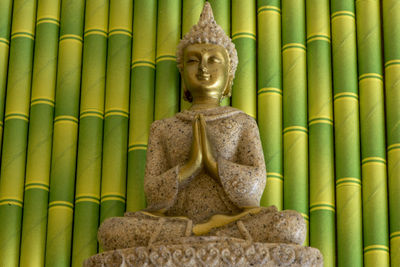 Statue of buddha in temple outside building