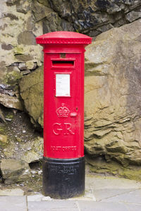 Close-up of red mailbox on wall