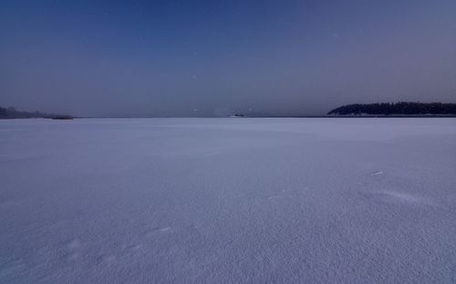 Scenic view of frozen lake against clear sky at night