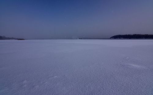 Scenic view of frozen lake against clear sky at night