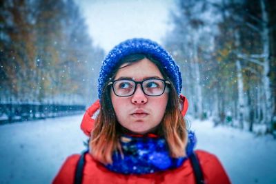 Portrait of smiling woman in snow during winter