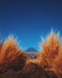 Distant view of mountain at atacama desert against clear blue sky