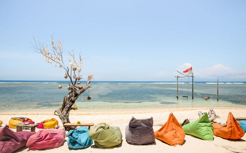 Colorful bean bags at beach on sunny day