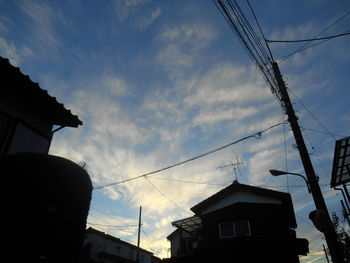 Low angle view of houses against cloudy sky