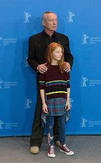 Full length of young couple standing against blue background