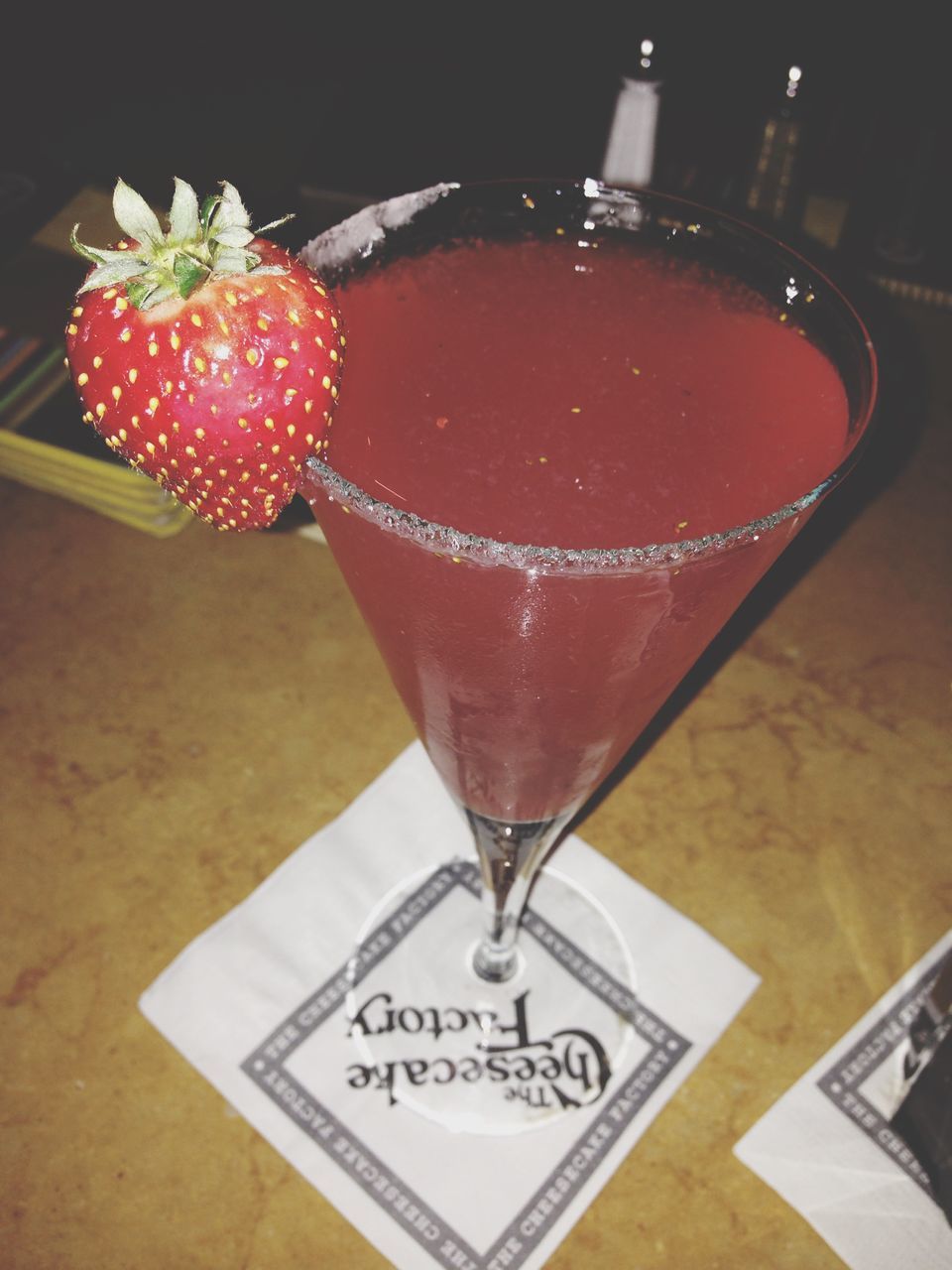 indoors, table, food and drink, red, still life, freshness, close-up, high angle view, text, drink, fruit, food, strawberry, communication, western script, no people, restaurant, decoration, refreshment, sweet food