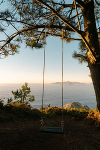 View of the monteferro swing at sunset with the cies islands in the background. nigran - galicia