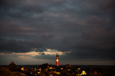 Lighthouse against sky at sunset