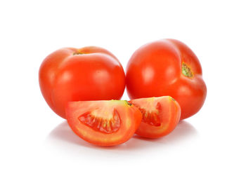 Close-up of tomatoes against white background