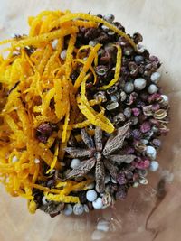 High angle view of yellow flowers on table