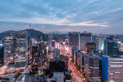 High angle view of illuminated buildings against sky in city