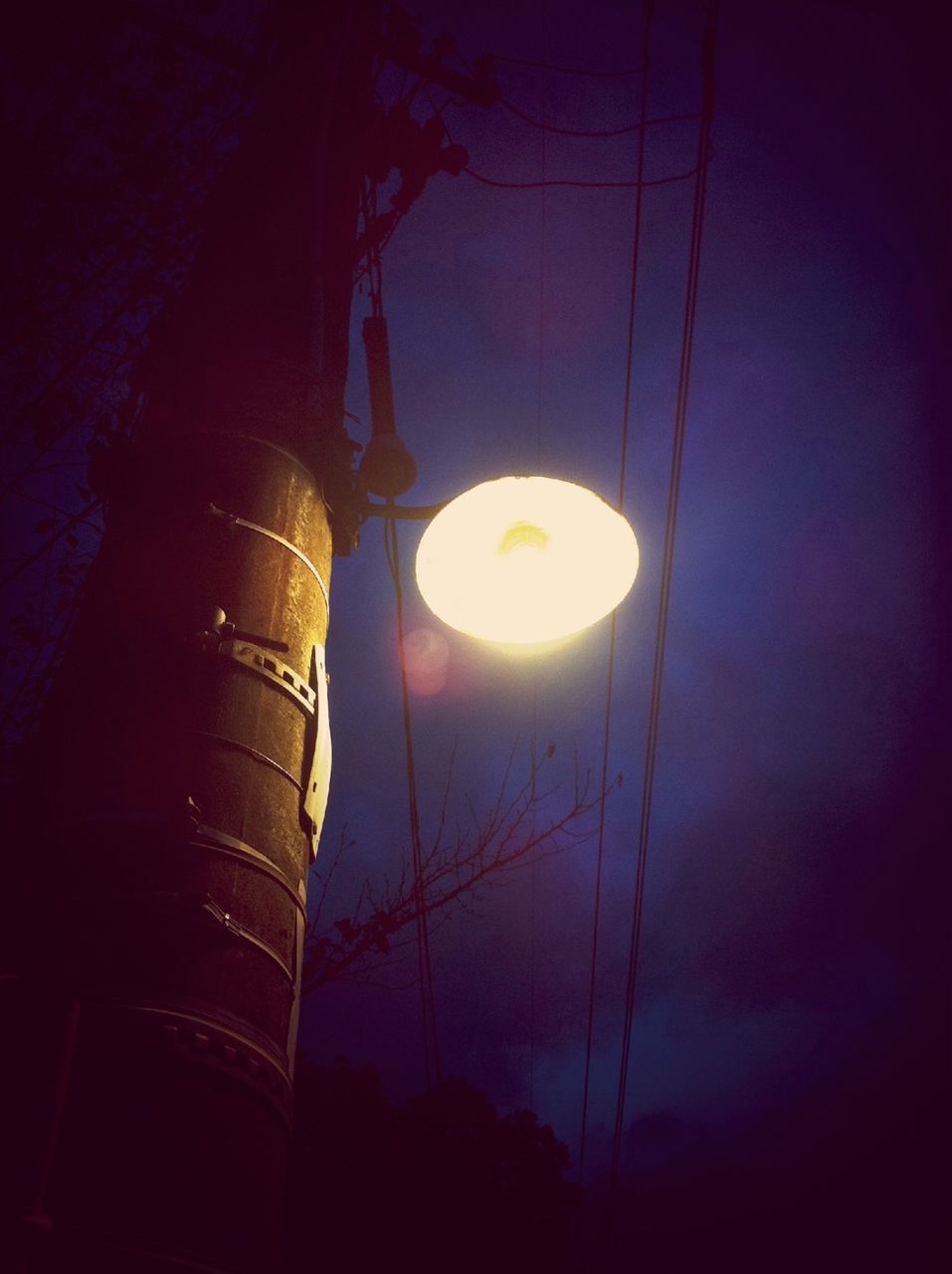 low angle view, built structure, architecture, illuminated, sky, lighting equipment, building exterior, electricity, night, silhouette, street light, electric light, no people, dark, outdoors, electric lamp, religion, dusk, building, glowing