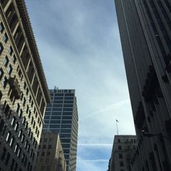 Low angle view of modern building against cloudy sky