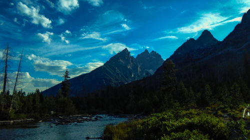 Scenic view of mountains against cloudy sky
