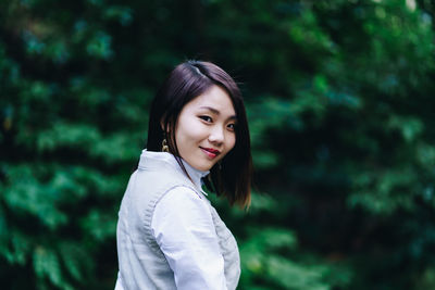 Portrait of smiling woman standing outdoors