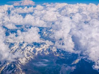 Scenic view of mountains against cloudy sky