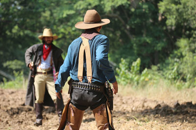 Rear view of man standing on field
