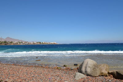 Scenic view of sea against clear blue sky