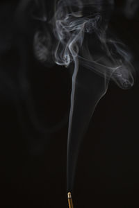 Close-up of smoke emitting from black background