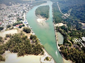 High angle view of river amidst trees in city