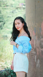 Portrait of a smiling young woman standing outdoors