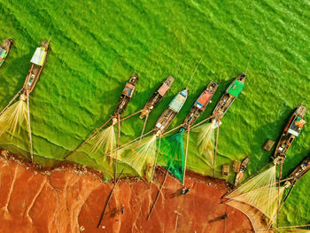 Aerial view of fishing boat moored at harbor