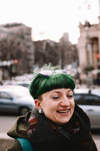 Portrait of smiling young woman in city