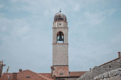 Low angle view of church bell tower against sky