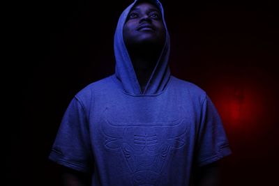 Close-up of mid adult man against black background