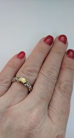 Close-up of woman hand over red background