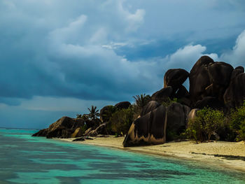 Panoramic view of rocks on beach against sky