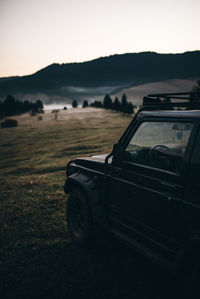 Car on field against sky