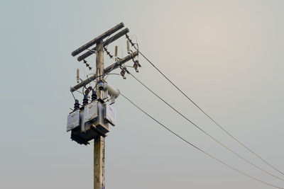 Low angle view of crane against clear sky
