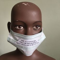 Close-up of mannequin with mask and quotes