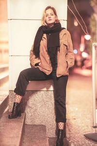 Portrait of young woman sitting outdoors